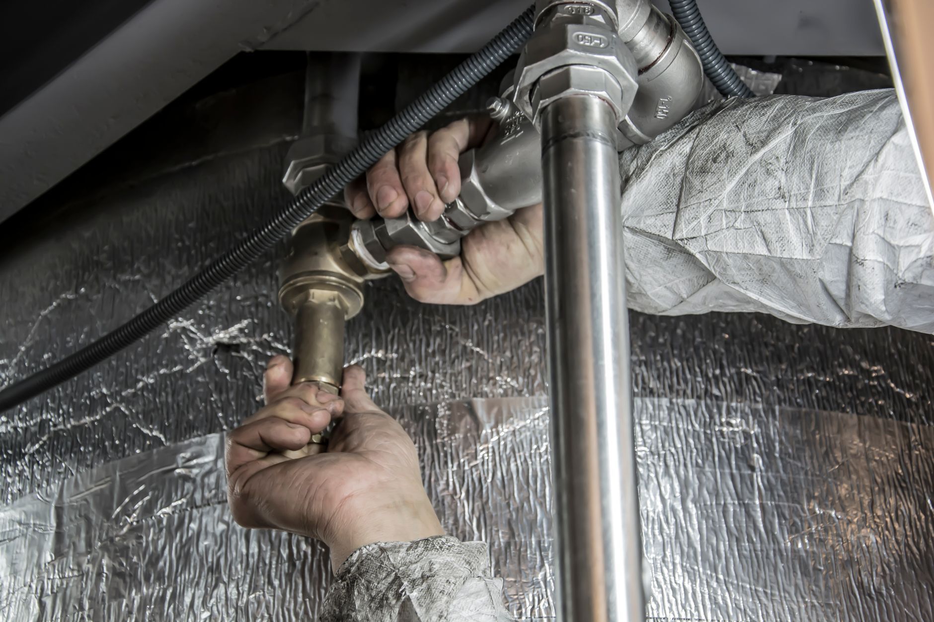 A Copperfern plumber fitting new supply lines under a Roseville house.
